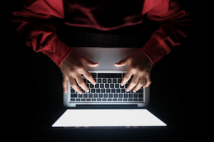 Hands on a laptop keyboard